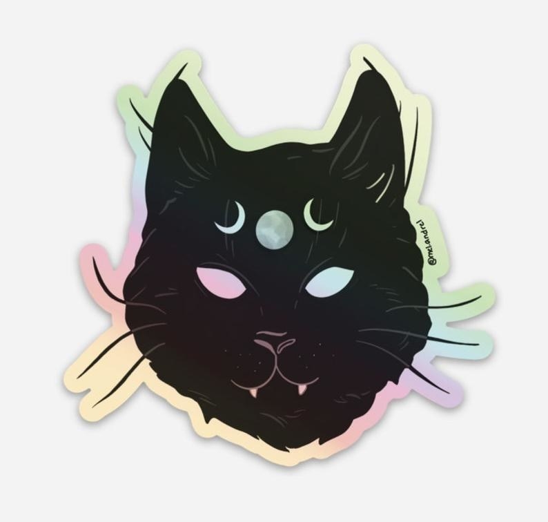 a black cat sticker with moons on the cat&#x27;s forehead 