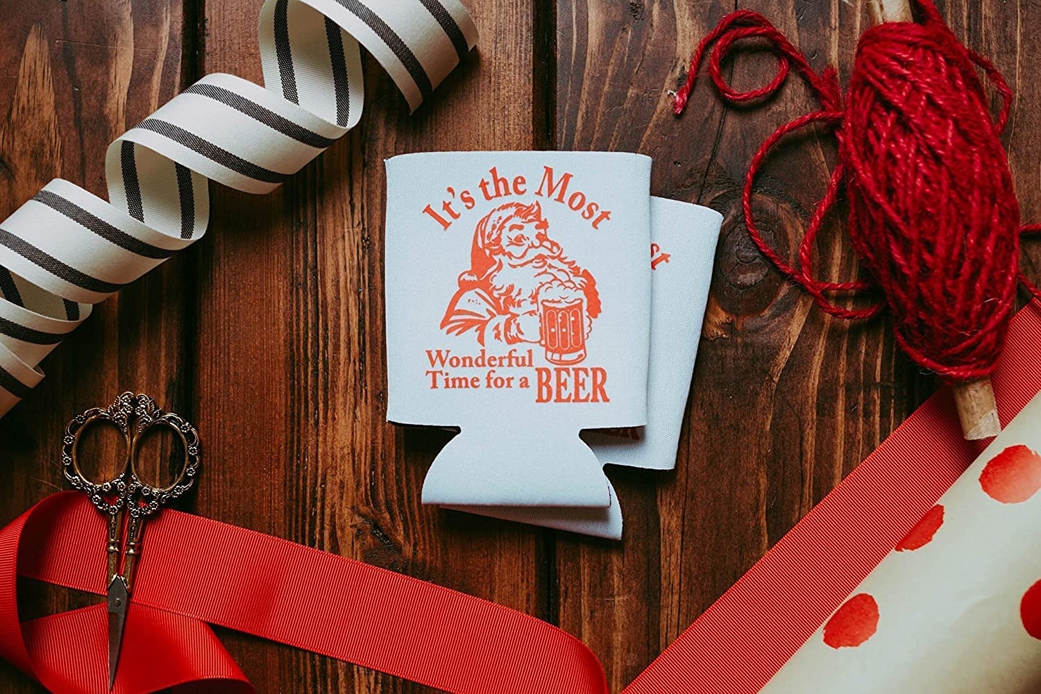 two white coozies with santa on it that says it&#x27;s the most wonderful time for a beer