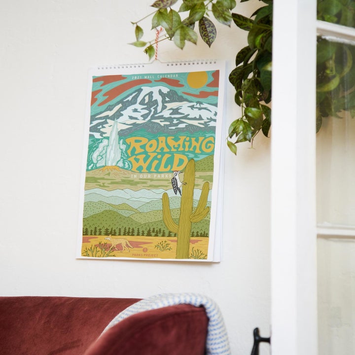 the calendar featuring a desert landscape hanging on a wall 