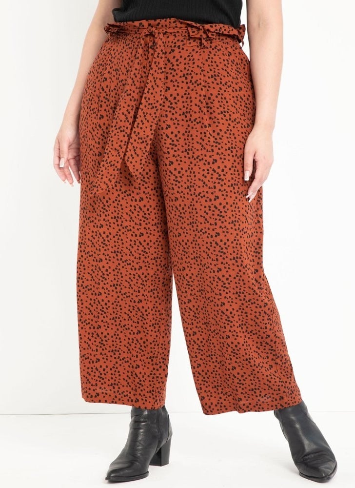 model wears dotted wide leg paperbag waisted pants