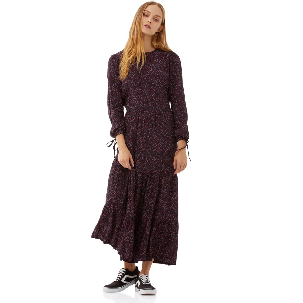 model wears dotted tiered maxi dress