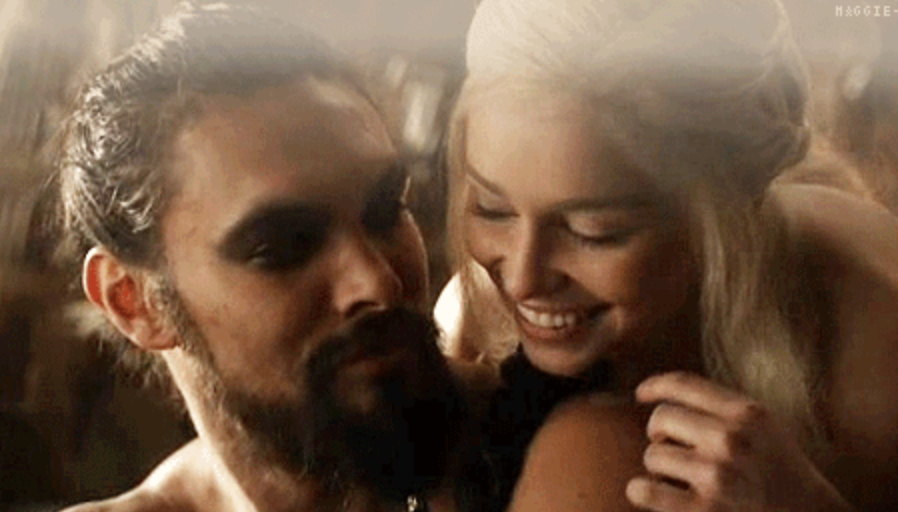 Daenerys and Khal Drogo smiling while she embraces him.