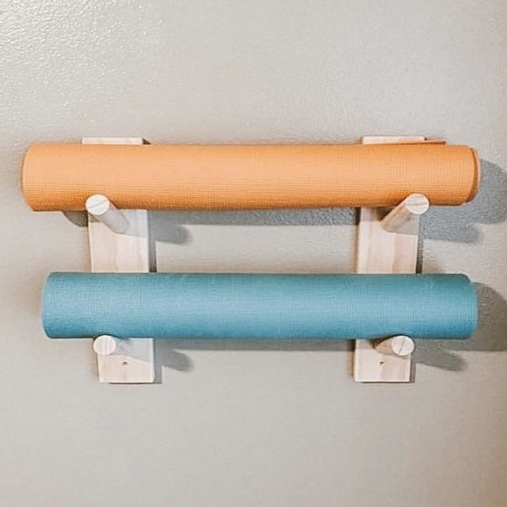the mat holder holding two yoga mats