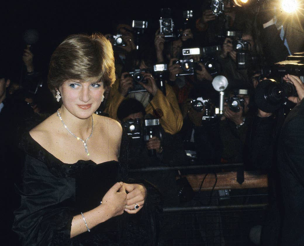 Princess Diana in front of a wall of paparazzi photographers