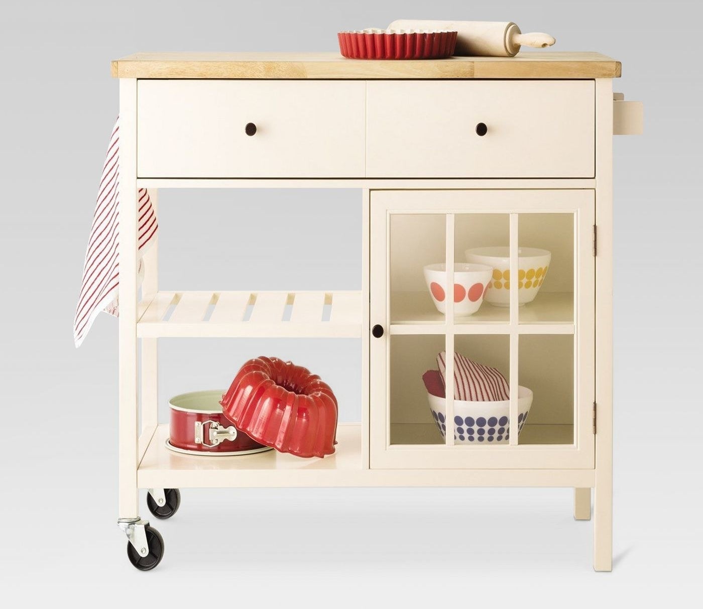 Cream kitchen island with wood top and wheels to easily move it