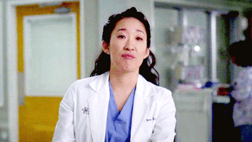 Christina Yang (Sandra Oh) shifts and pouts her lips before looking off to the side on Grey&#x27;s Anatomy
