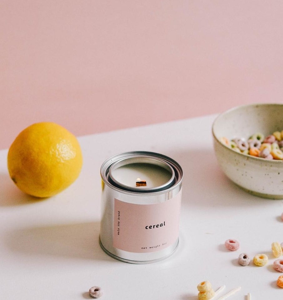 The candle surrounded by pieces of cereal