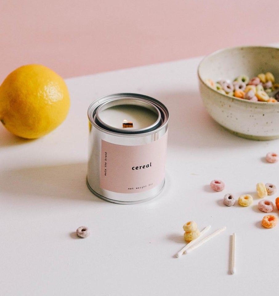 The candle surrounded by pieces of cereal