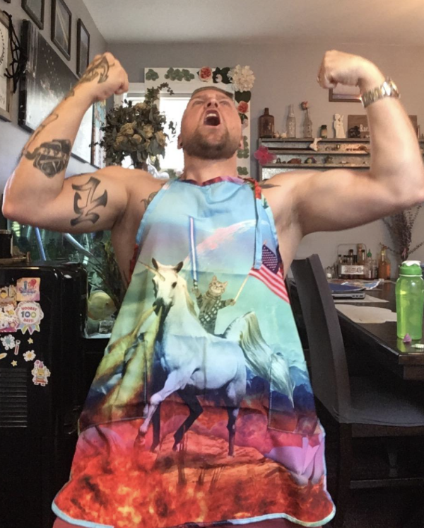 Reviewer photo of man wearing cat and unicorn kitchen apron