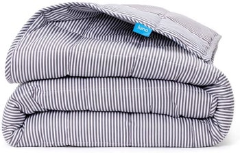 A folded blanket in striped white/grey