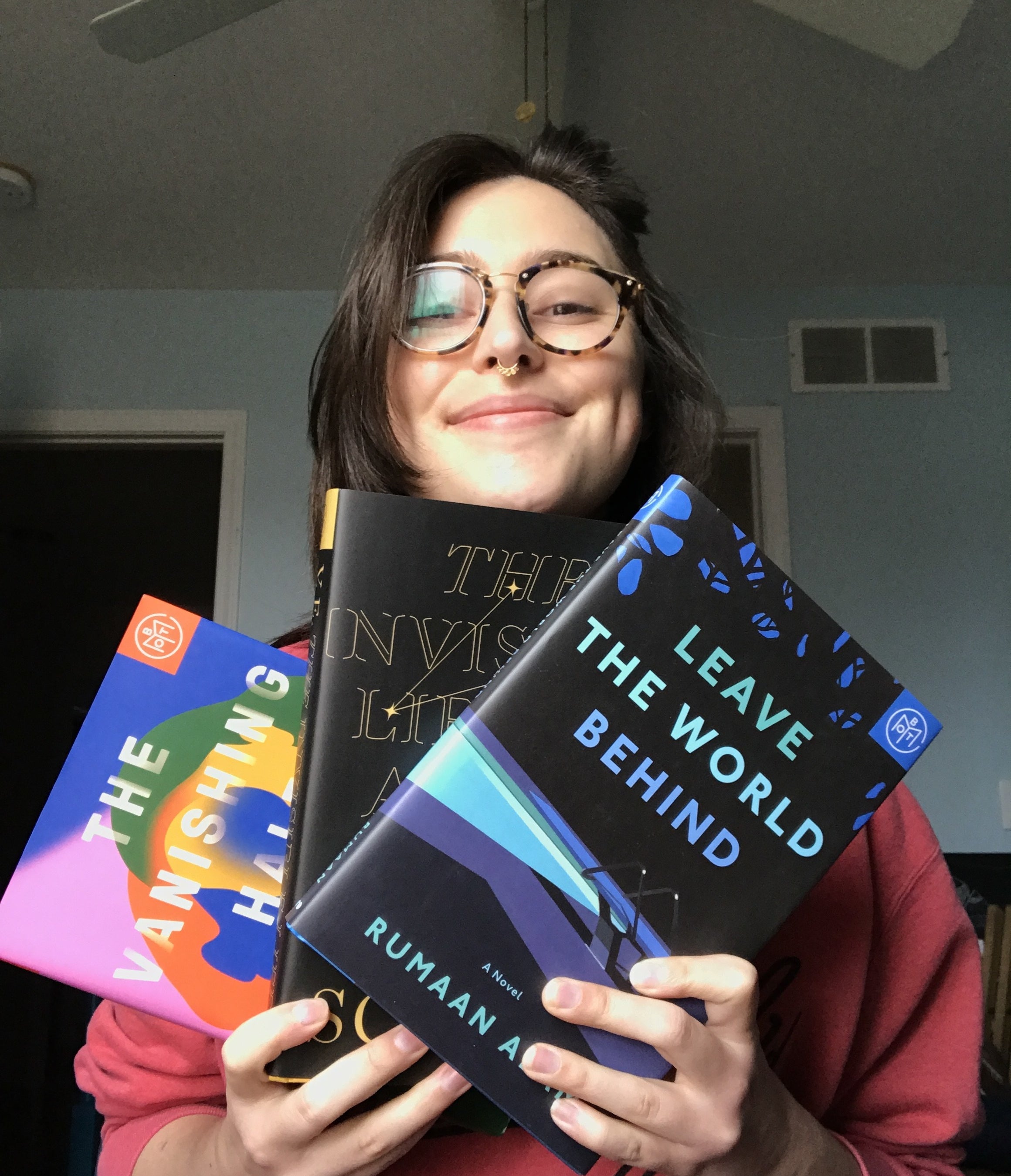 writer holding the books &quot;leave the world behind&quot; &quot;the invisible life of Adie LaRue&quot; and &quot;the vanishing half&quot;