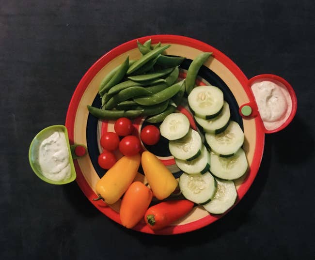 Reviewer image of a plate full of veggies and dip clips attached to the side with dressings 