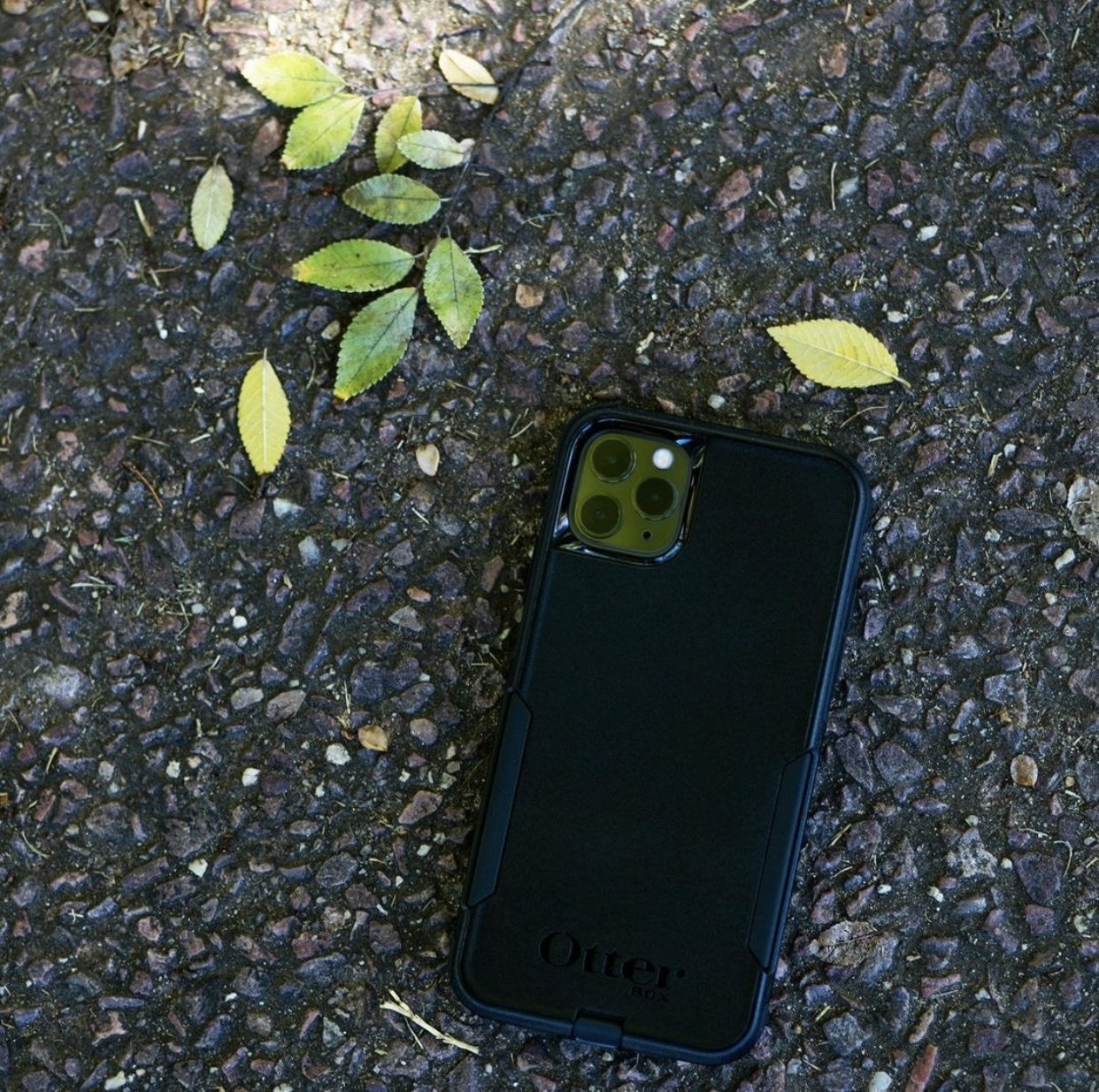 A black Otterbox on gravel