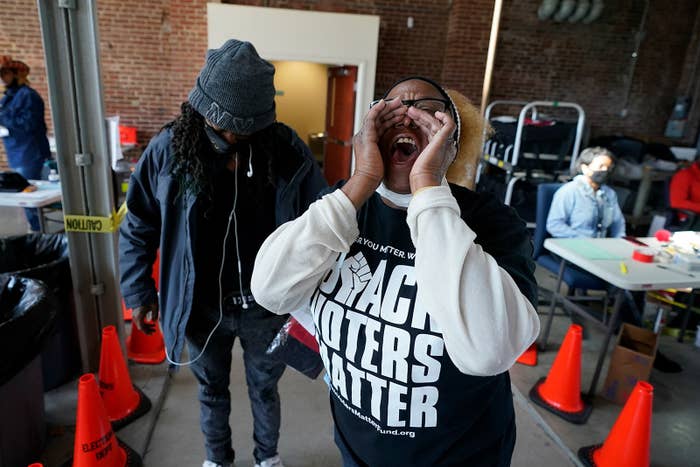 A black woman wears a shirt that says "Black Voters Matter"