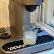 The Bartesian cocktail machine pouring out a cocktail 