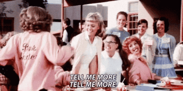 GIF from the film Grease with the caption, &quot;Tell me more, Tell me more&quot;