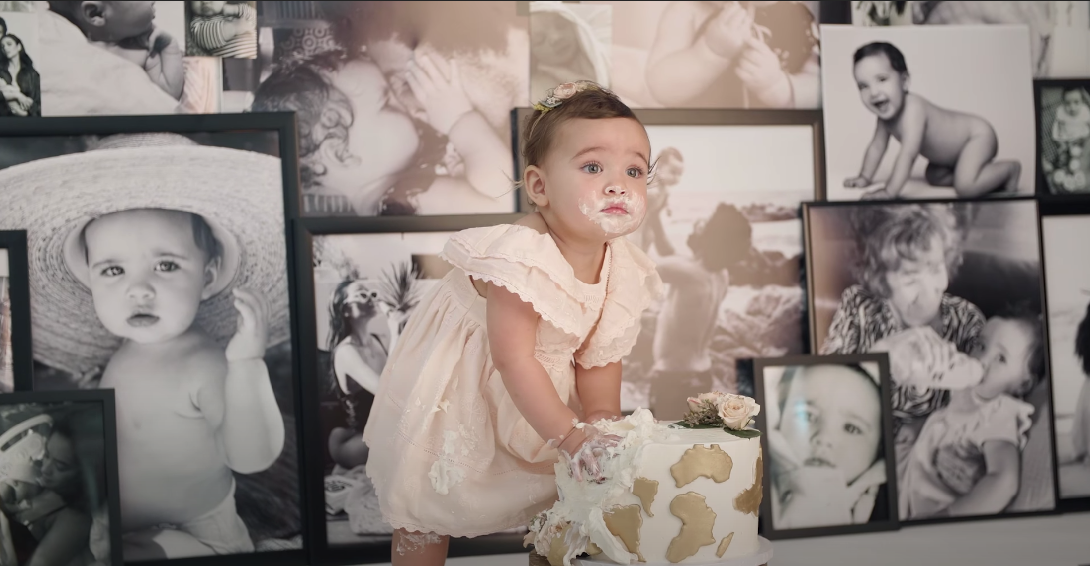 Atlas wears a dress and has birthday cake all over her face for her photo shoot