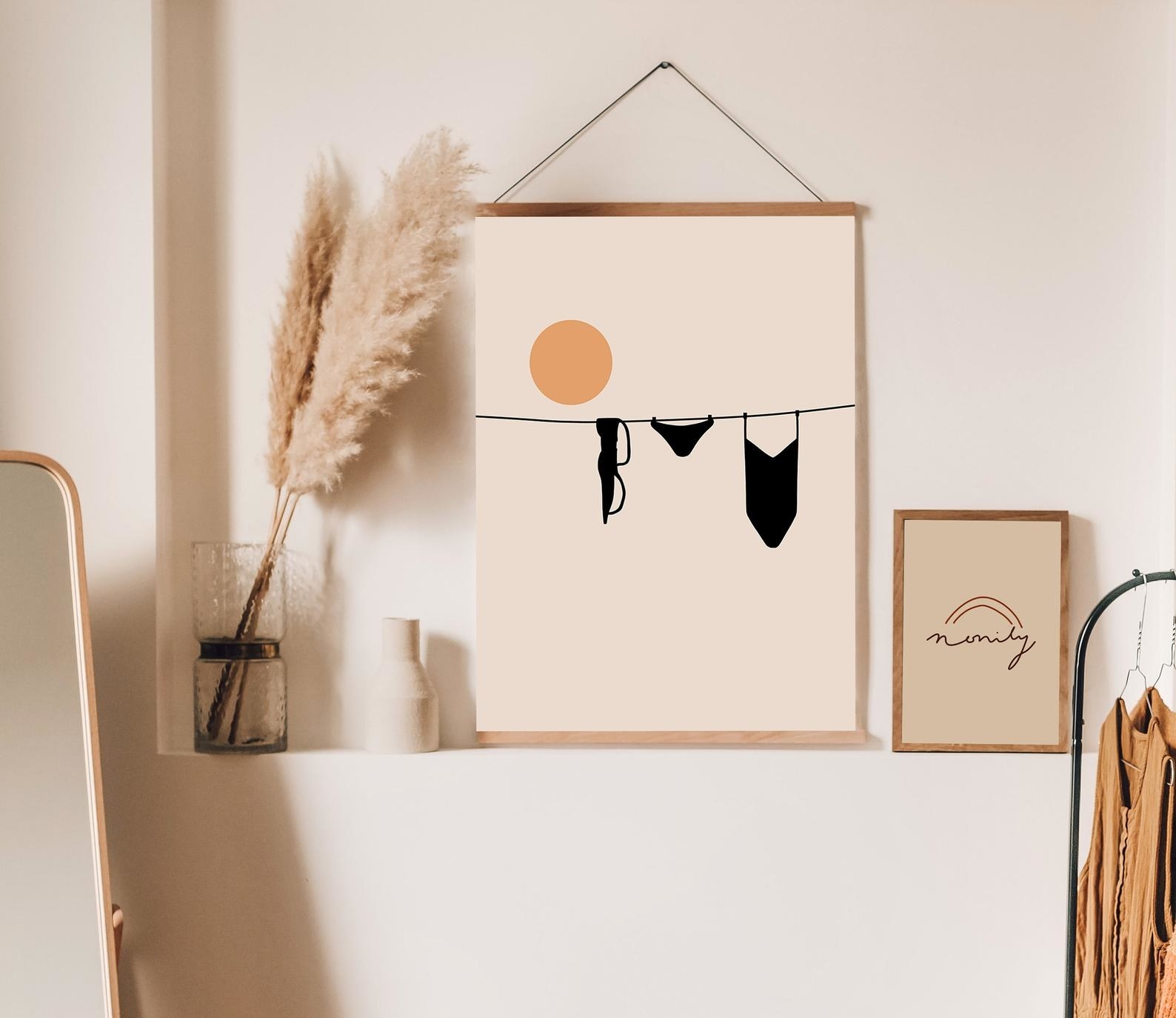 The clothes line art print hanging on a wall