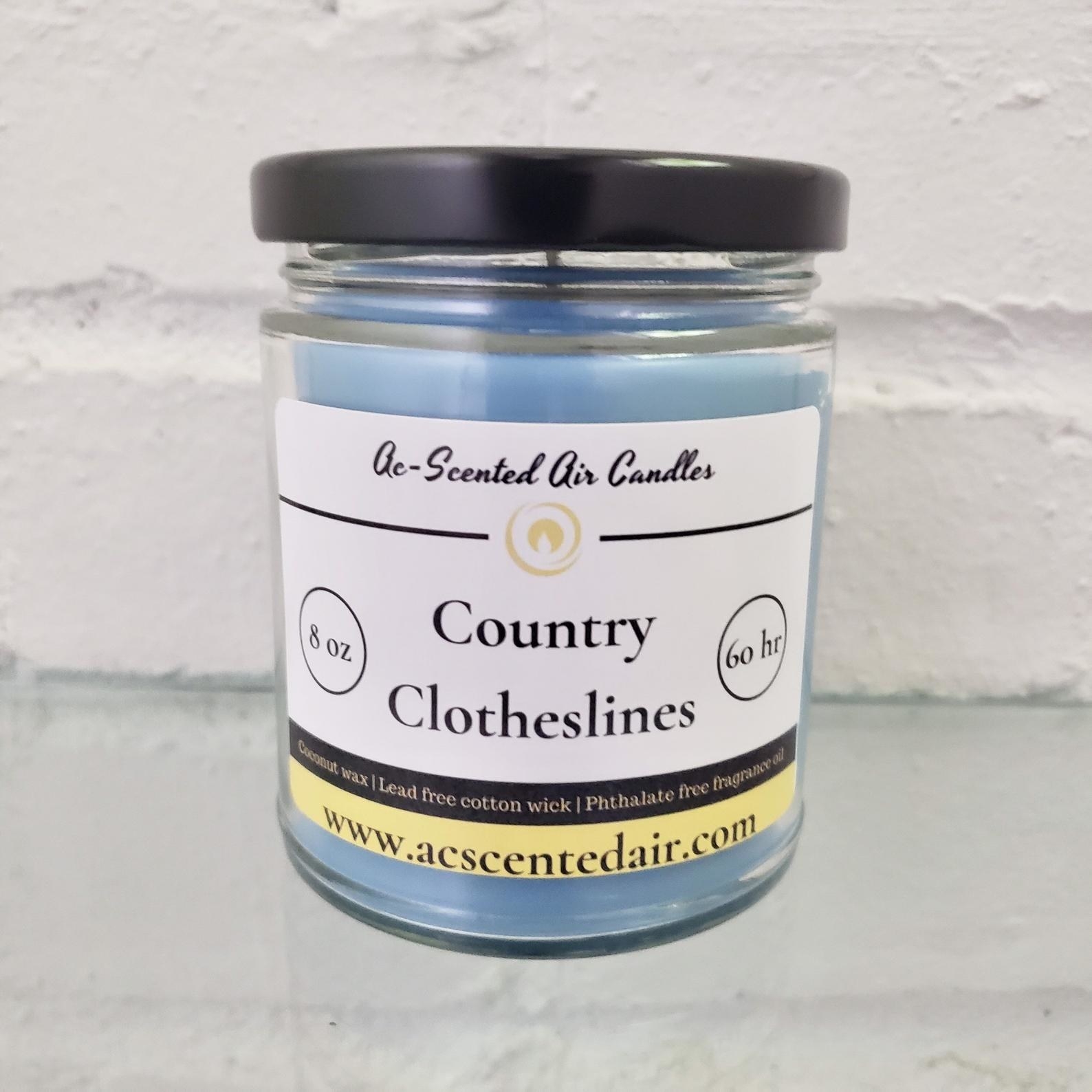 A scented candle in the country clothesline fragrance 