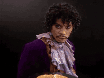 Dave Chappelle as Prince waving a plate of pancakes