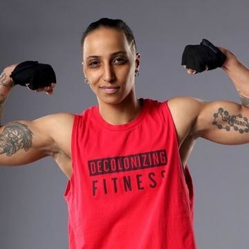 a model wearing the muscle tank and flexing their arms 