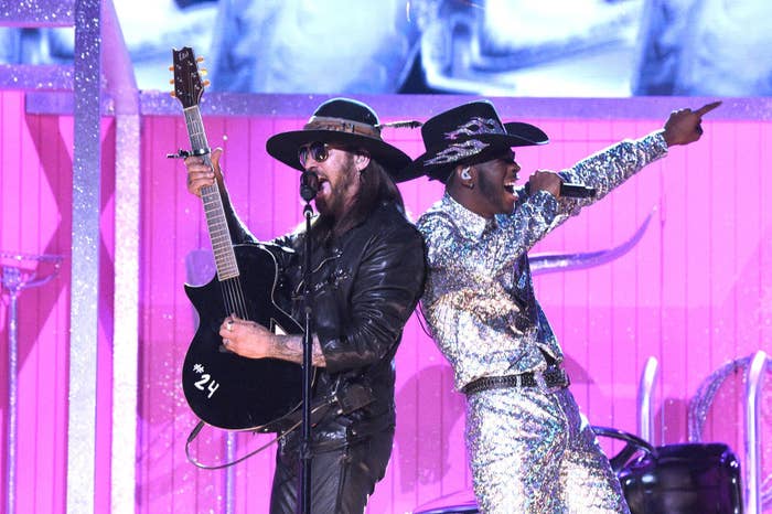 Billie Ray Cyrus perform the song wearing flashy suits and cowboy hats on the Grammy Awards