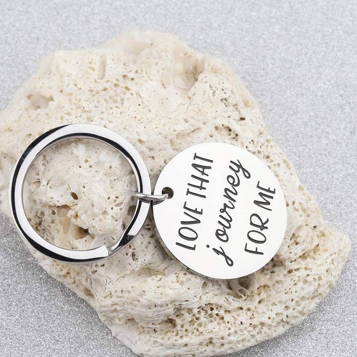 The silver keyring with a round engraved charm