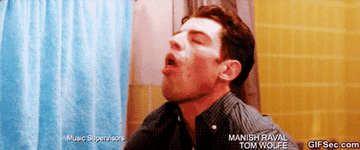 A GIF of Schmidt from &quot;New Girl&quot; gagging