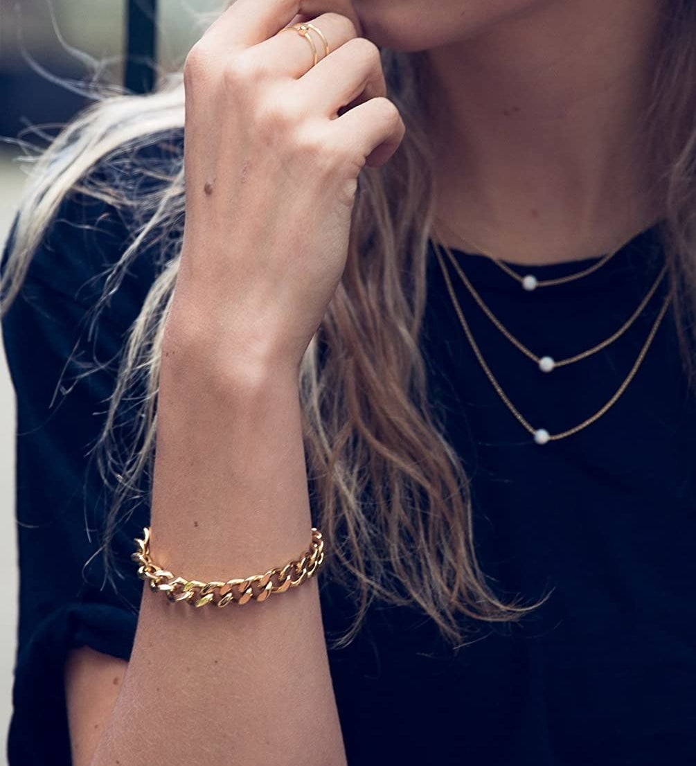 model wearing the gold chain bracelet