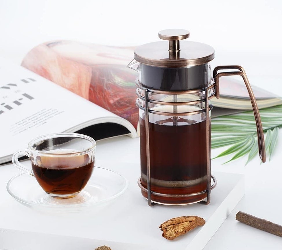the heat-resistant glass french press with a stainless steal lid, handle, and filter screen 