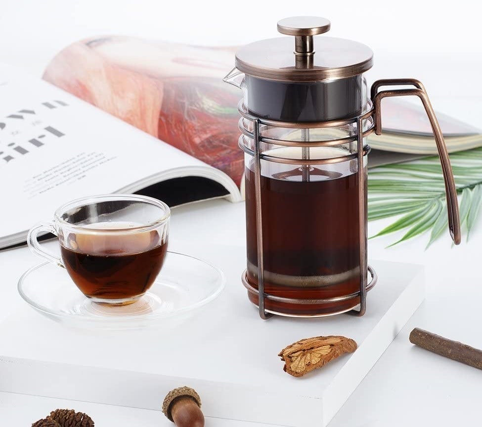 the heat-resistant glass french press with a stainless steal lid, handle, and filter screen 