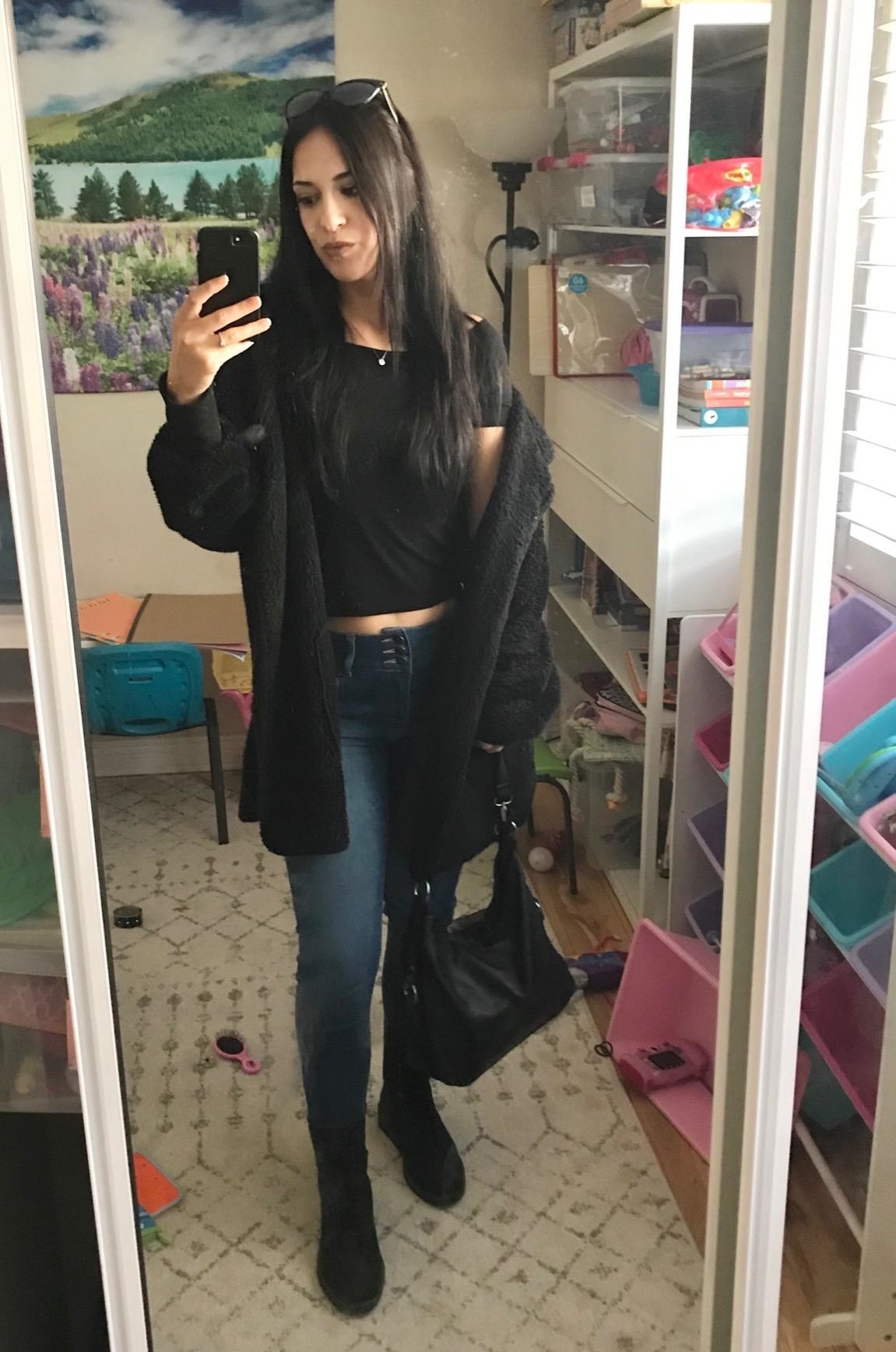 Reviewer wearing black sherpa hoodie