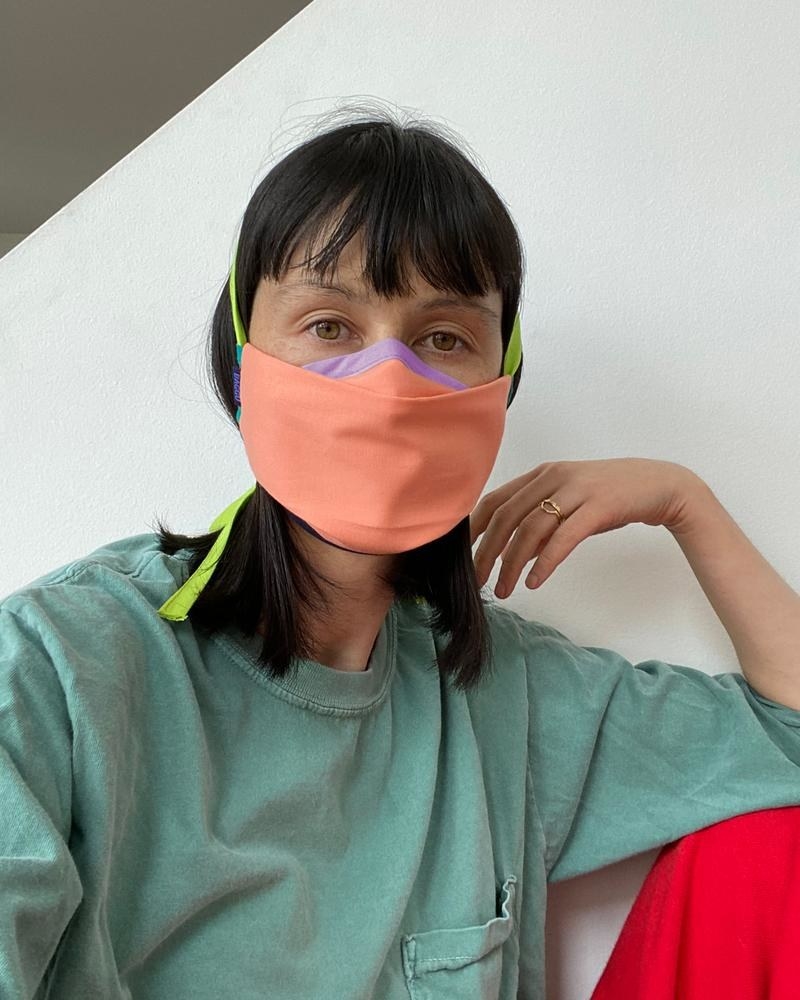 model wears neon mask with tie straps 