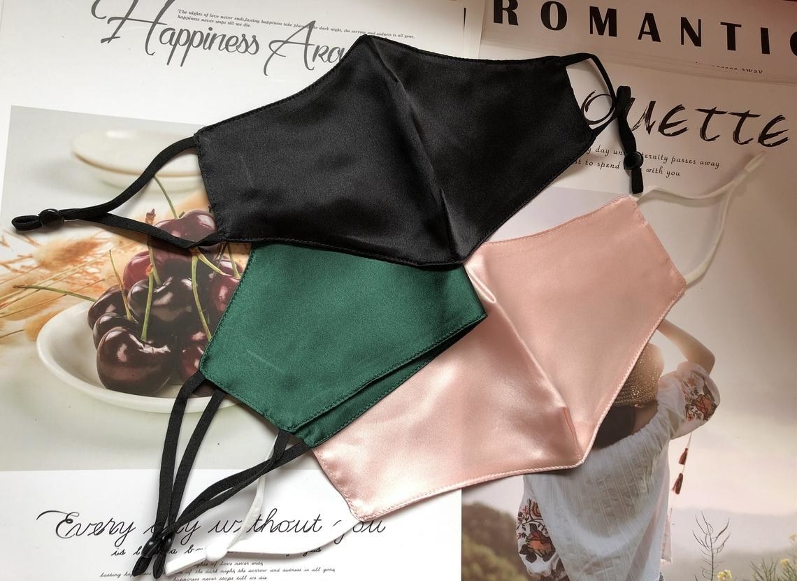 three silk masks in black, green, and pink 