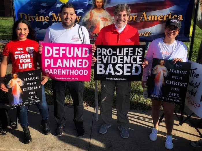 Protesters hold signs opposing abortion