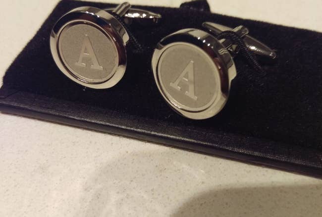 A reviewer's pair of the silver tone cufflinks in the letter A, with a rounded shape, outside lip around the engraving