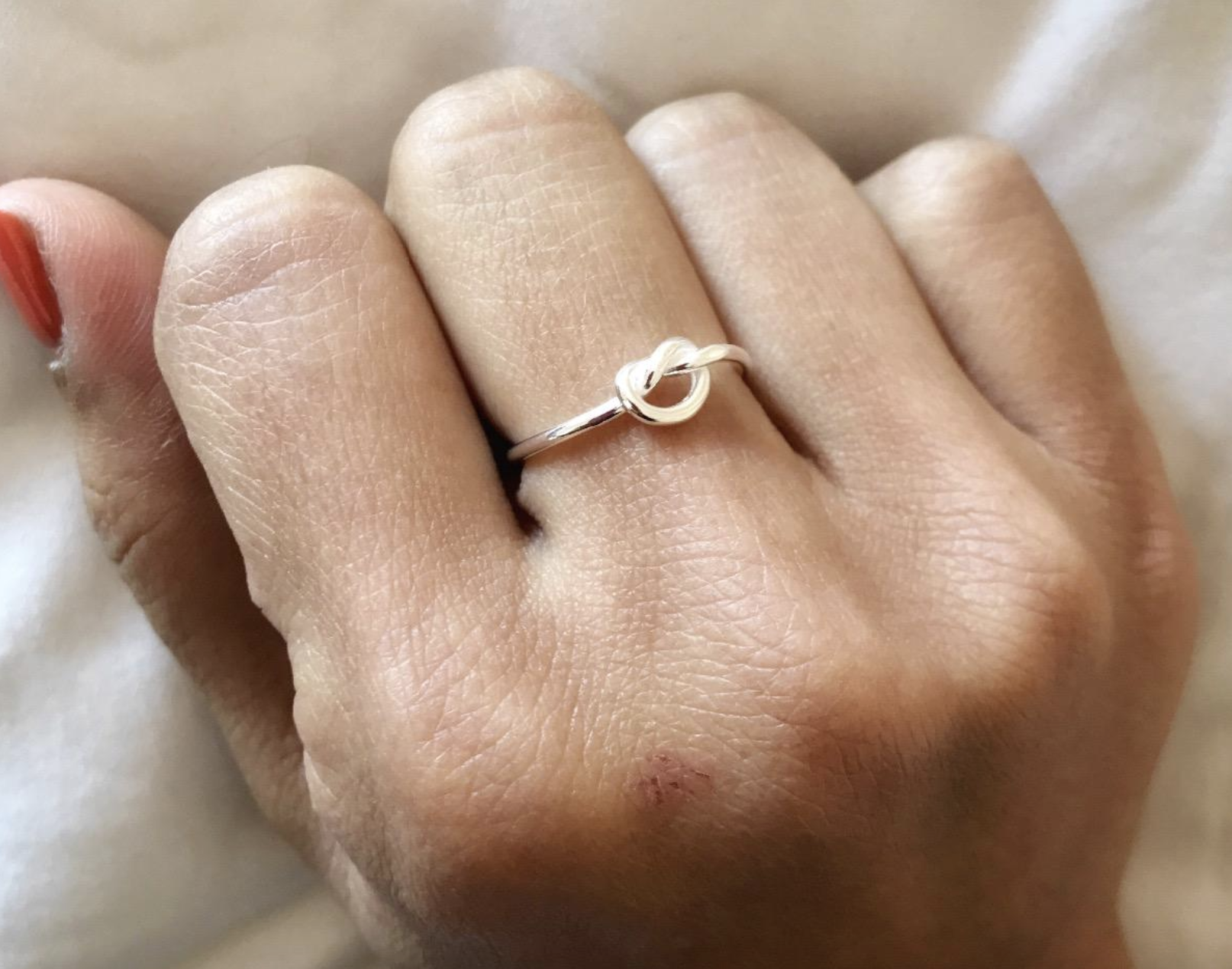 reviewer wearing the silver knot ring
