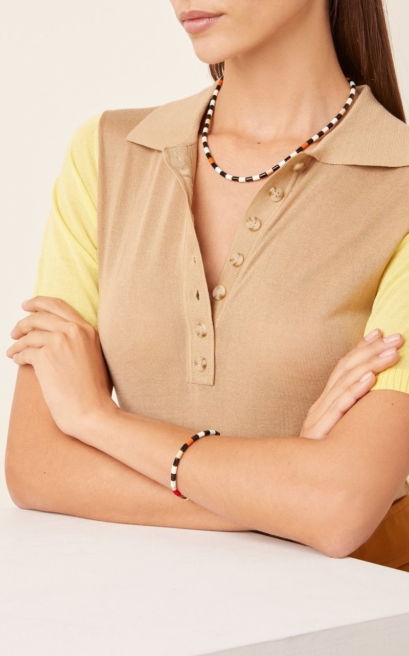 Neutral-toned Roxanne Assoulin terrazzo enamel bracelet worn on model 