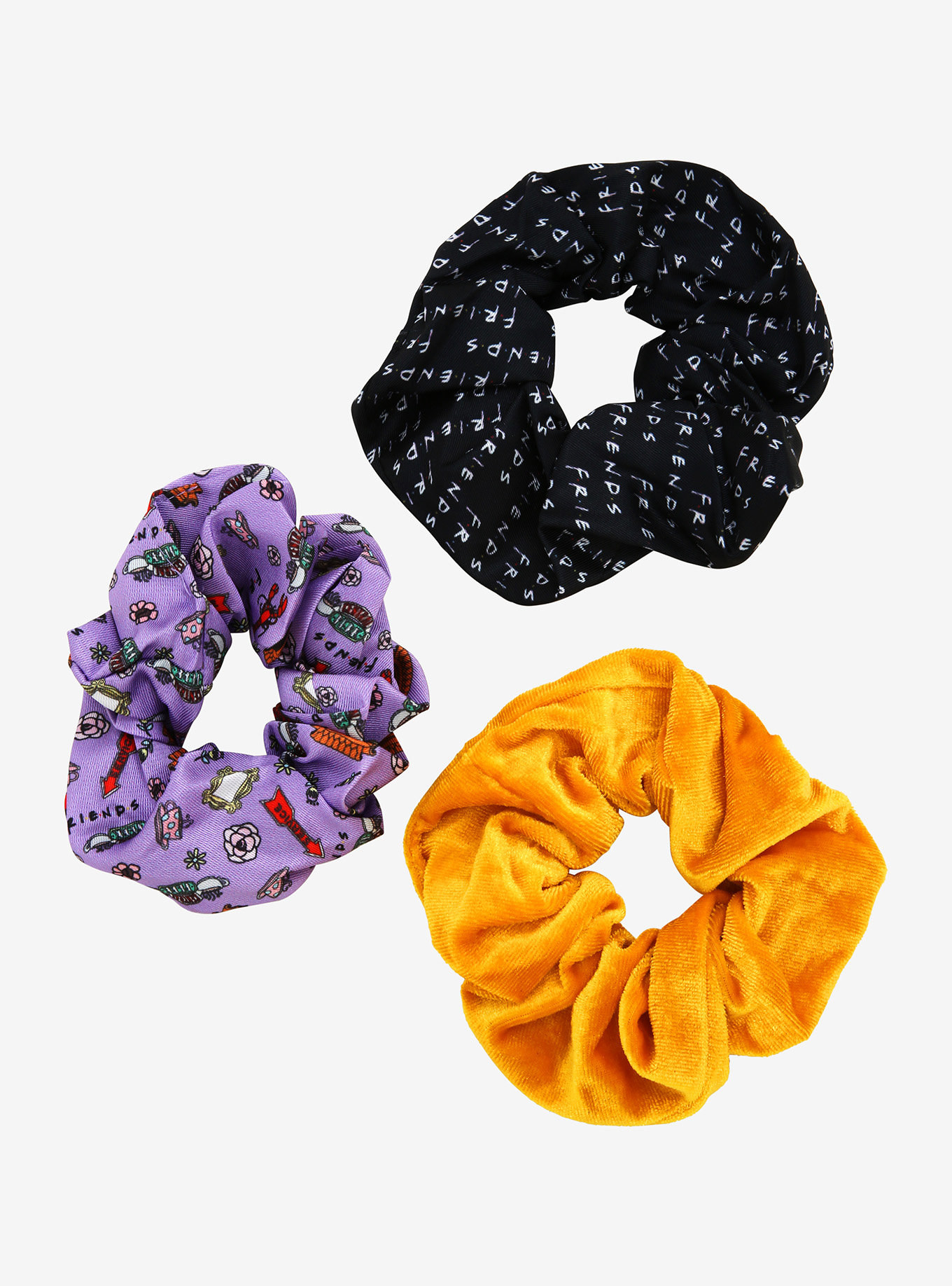 a black scrunchie with the friends logo all over it, a purple one with different icons from the show, and a yellow velvet scrunchie