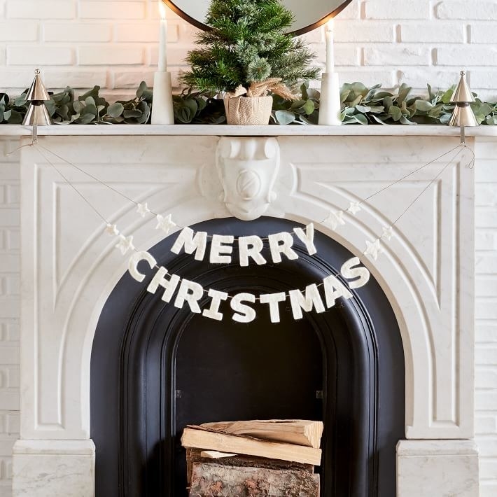 Merry Christmas garland strung across fireplace