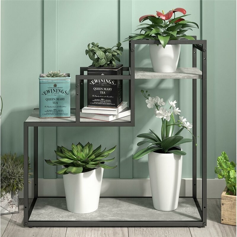 plant stand with metal frame and plants on the particleboard shelves