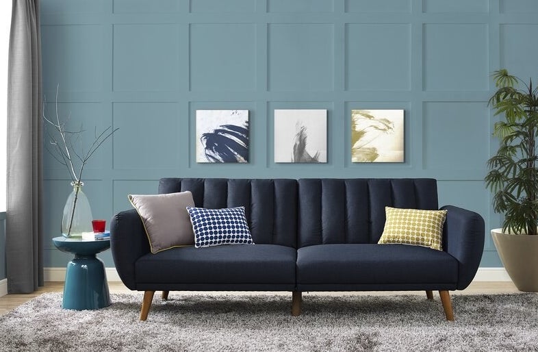 dark blue couch with throw pillows in living room 
