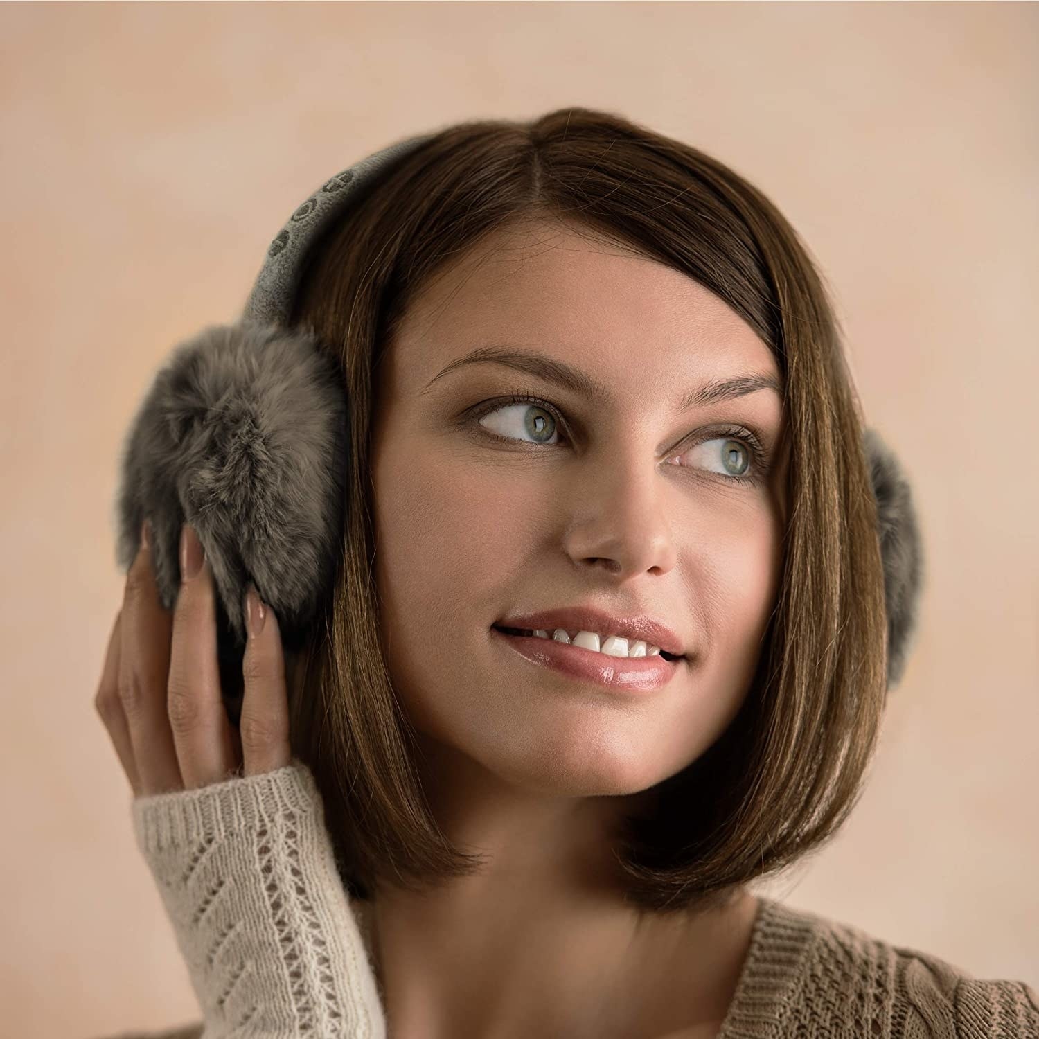 Model in the grey earmuffs with faux fur around the ears
