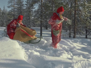 two people dressed as elves bringing a bag of presents on a sled