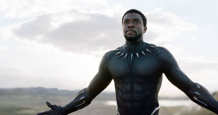 Still of Chadwick Boseman as Black Panther walking with his arms outstretched