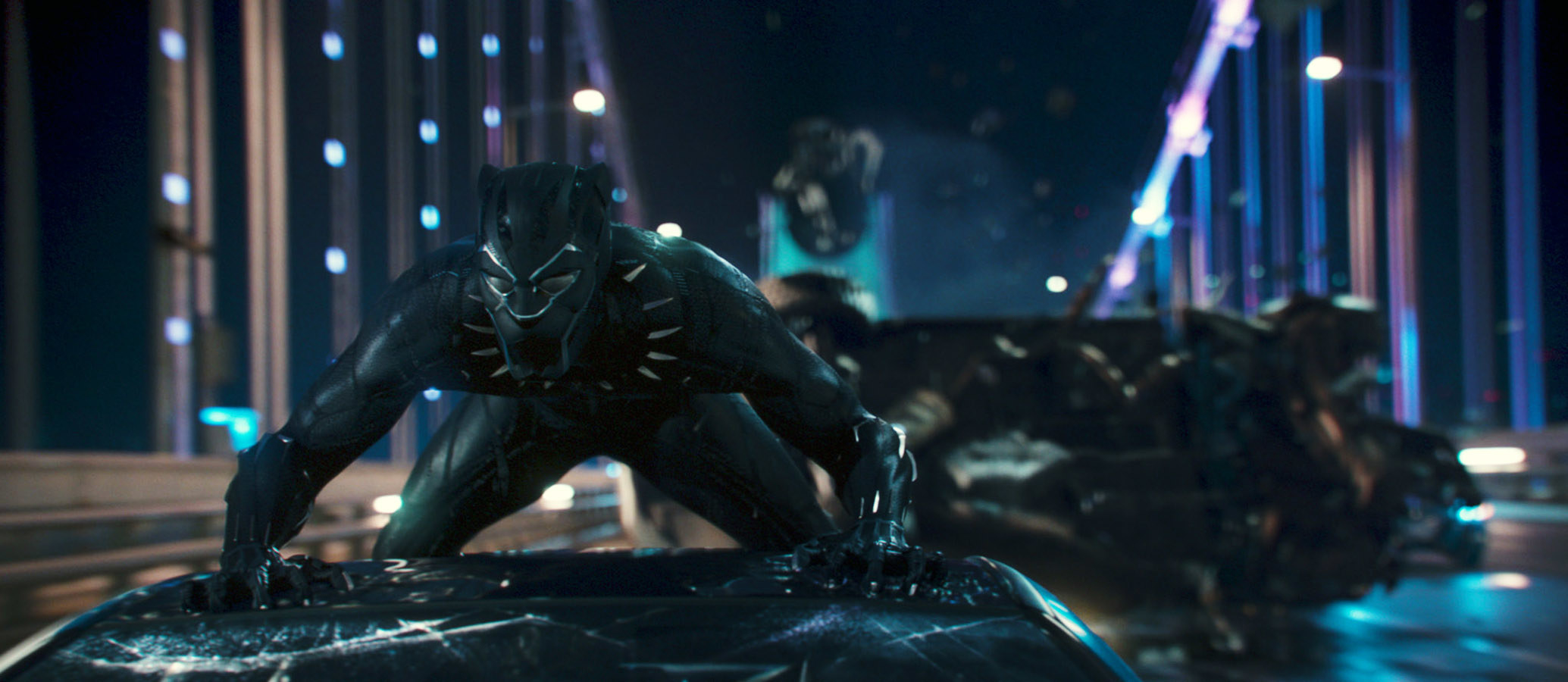 Chadwick Boseman as Black Panther on top of a moving vehicle