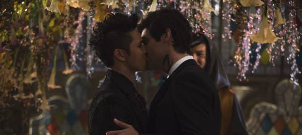 Magnus Bane (Harry Shum Jr.) and Alec Lightwood (Matthew Daddario) kiss under plants.