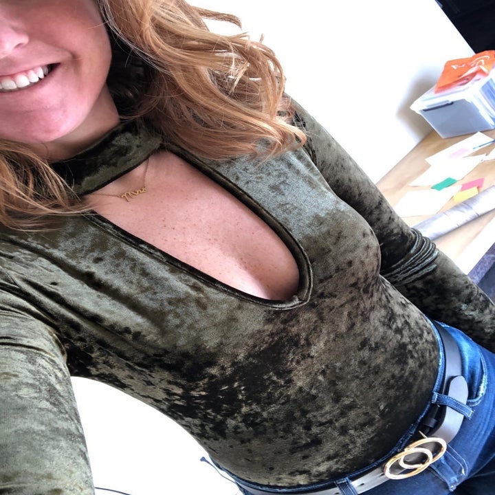 A reviewer wearing the bodysuit tucked into jeans