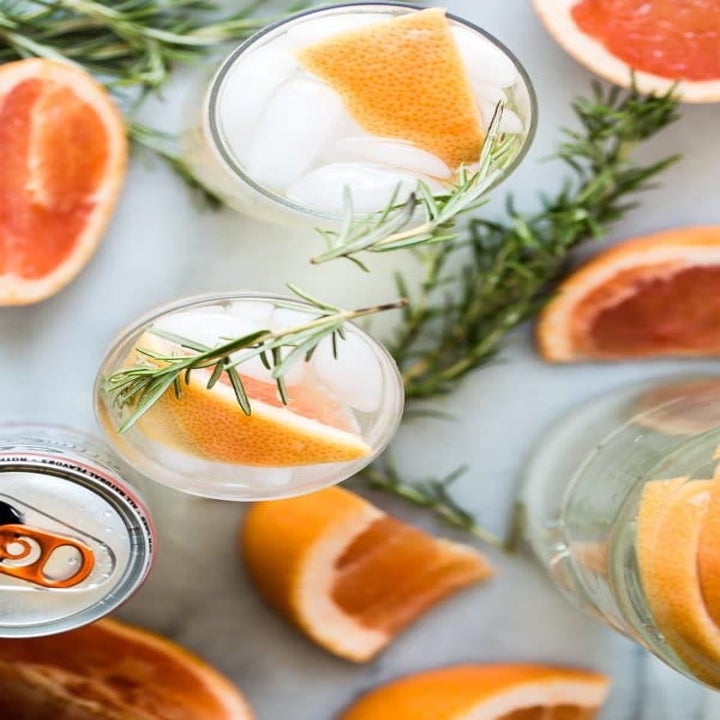 A top-down shot of two grapefruit and rosemary White Claw cocktails.
