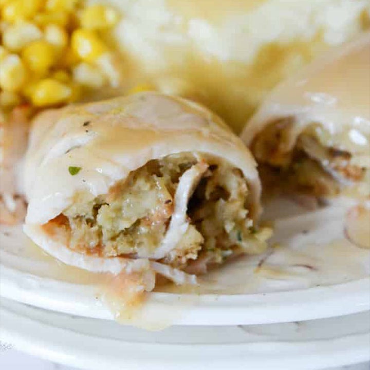 A turkey roll-up filled with stuffing and topped with gravy.